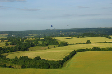 Two balloons in flight over fields in Oxfordshire